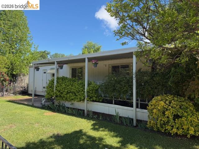 14192 Tuolumne Road, Unit 31 Sonora, CA 95370 - Photo 6 of 11 a view of a house with backyard sitting area and garden