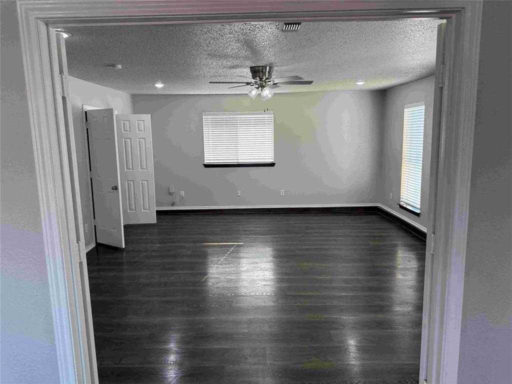 2959 Scott Mill Road Carrollton, TX 75007 - Photo 11 of 26 an empty room with wooden floor and windows