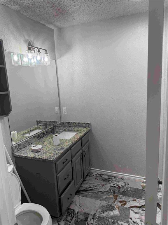 2959 Scott Mill Road Carrollton, TX 75007 - Photo 16 of 26 a bathroom with a granite countertop sink and a mirror