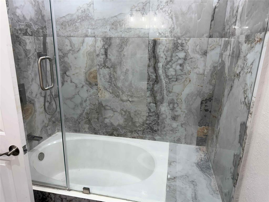 2959 Scott Mill Road Carrollton, TX 75007 - Photo 21 of 26 a bathroom with a bathtub