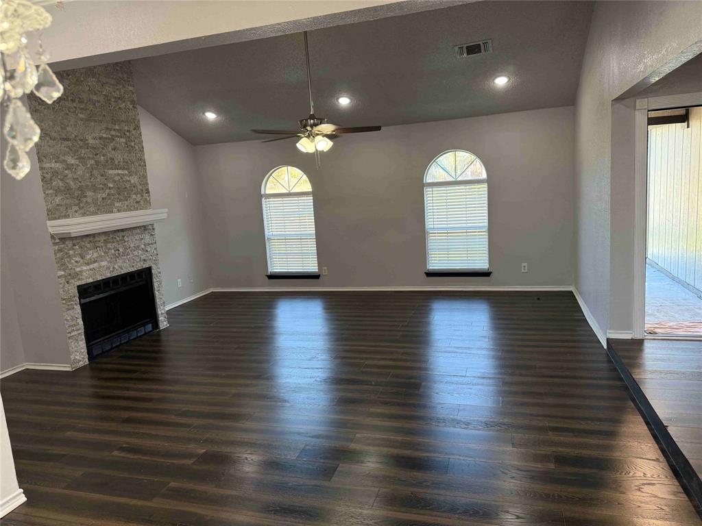 2959 Scott Mill Road Carrollton, TX 75007 - Photo 25 of 26 an empty room with wooden floor and a fireplace