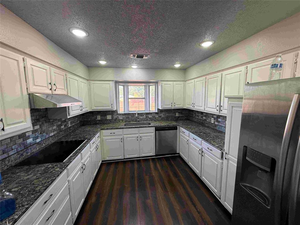 2959 Scott Mill Road Carrollton, TX 75007 - Photo 7 of 26 a large kitchen with a large window and stainless steel appliances