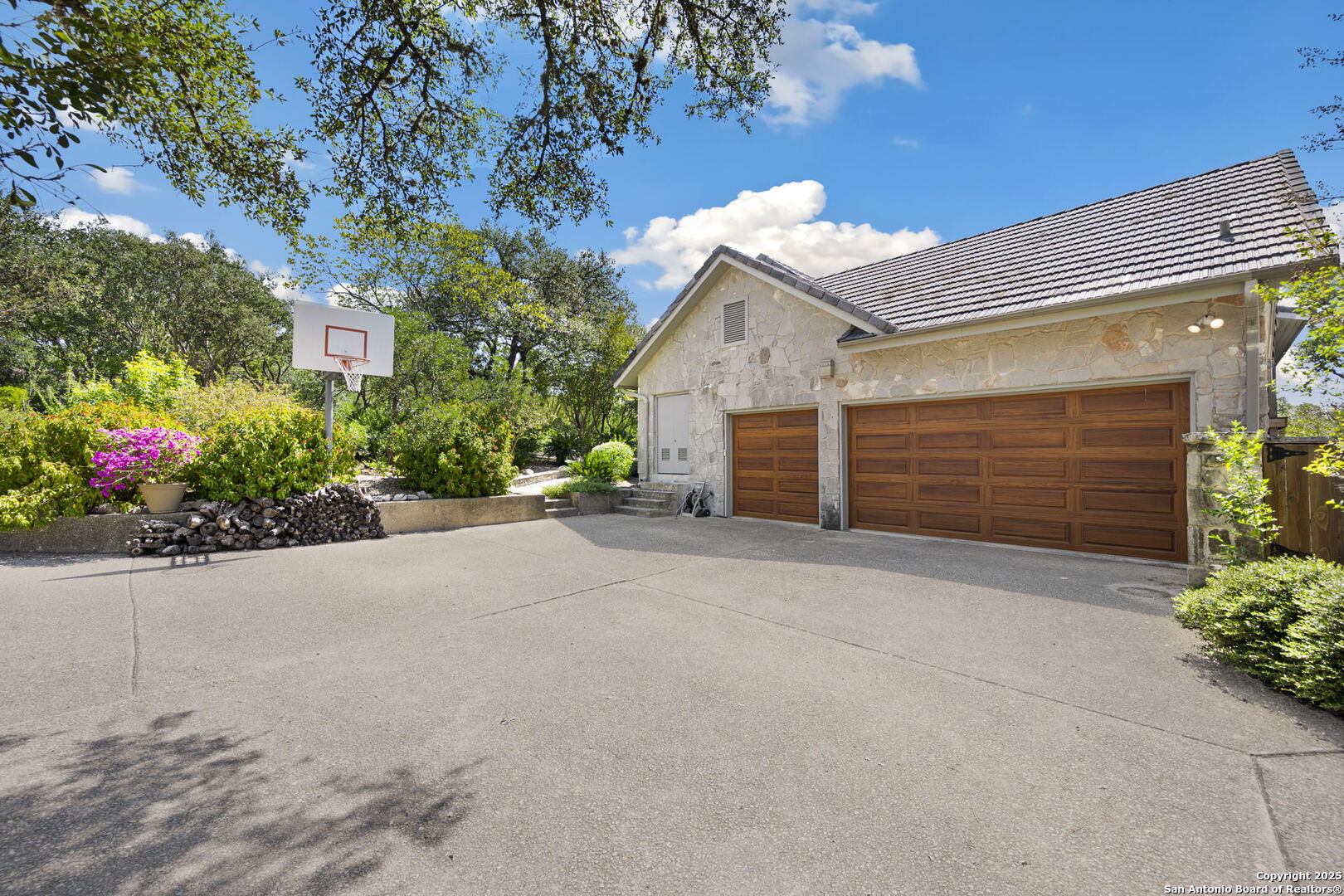 14819 Seven L Trail Helotes, TX 78023 - Photo 19 of 61 a view of a house with a yard and garage