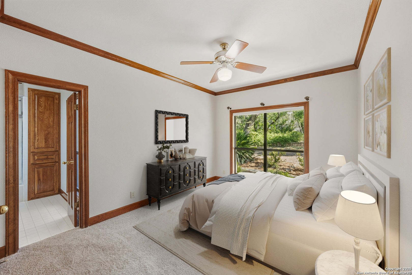 14819 Seven L Trail Helotes, TX 78023 - Photo 24 of 61 a bedroom with a bed and a chandelier