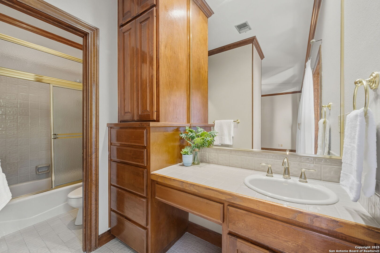 14819 Seven L Trail Helotes, TX 78023 - Photo 30 of 61 a bathroom with a granite countertop sink and a mirror