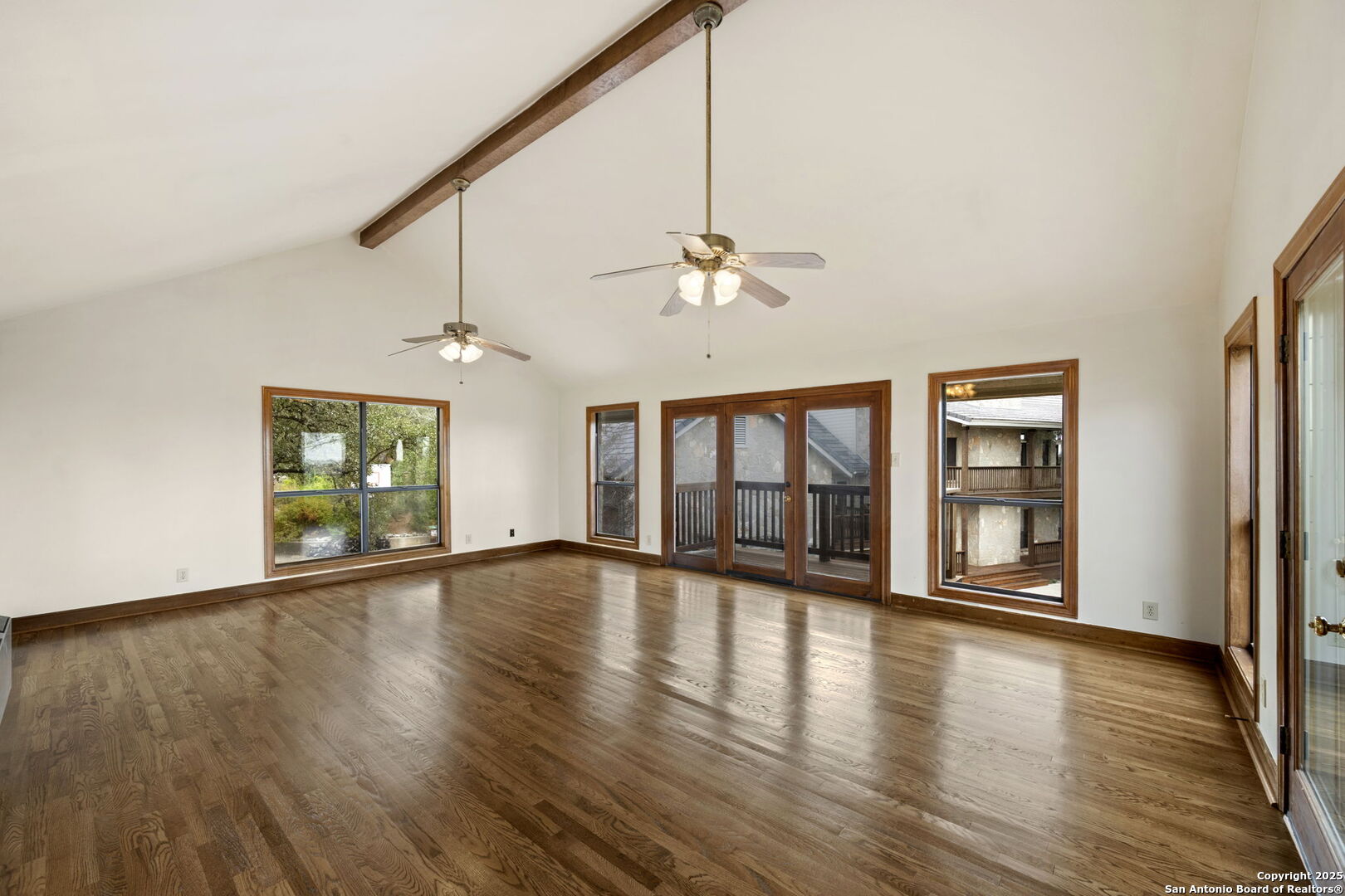 14819 Seven L Trail Helotes, TX 78023 - Photo 34 of 61 a view of an empty room with wooden floor and a window