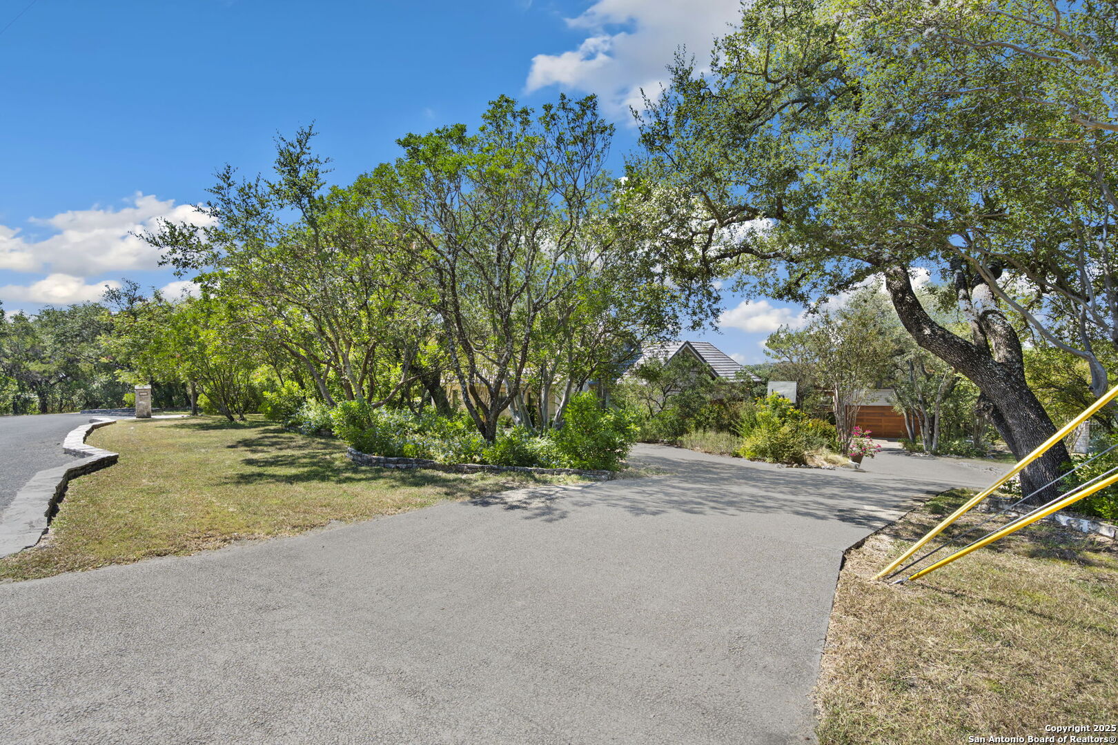14819 Seven L Trail Helotes, TX 78023 - Photo 36 of 61 a backyard of a house with table and chairs
