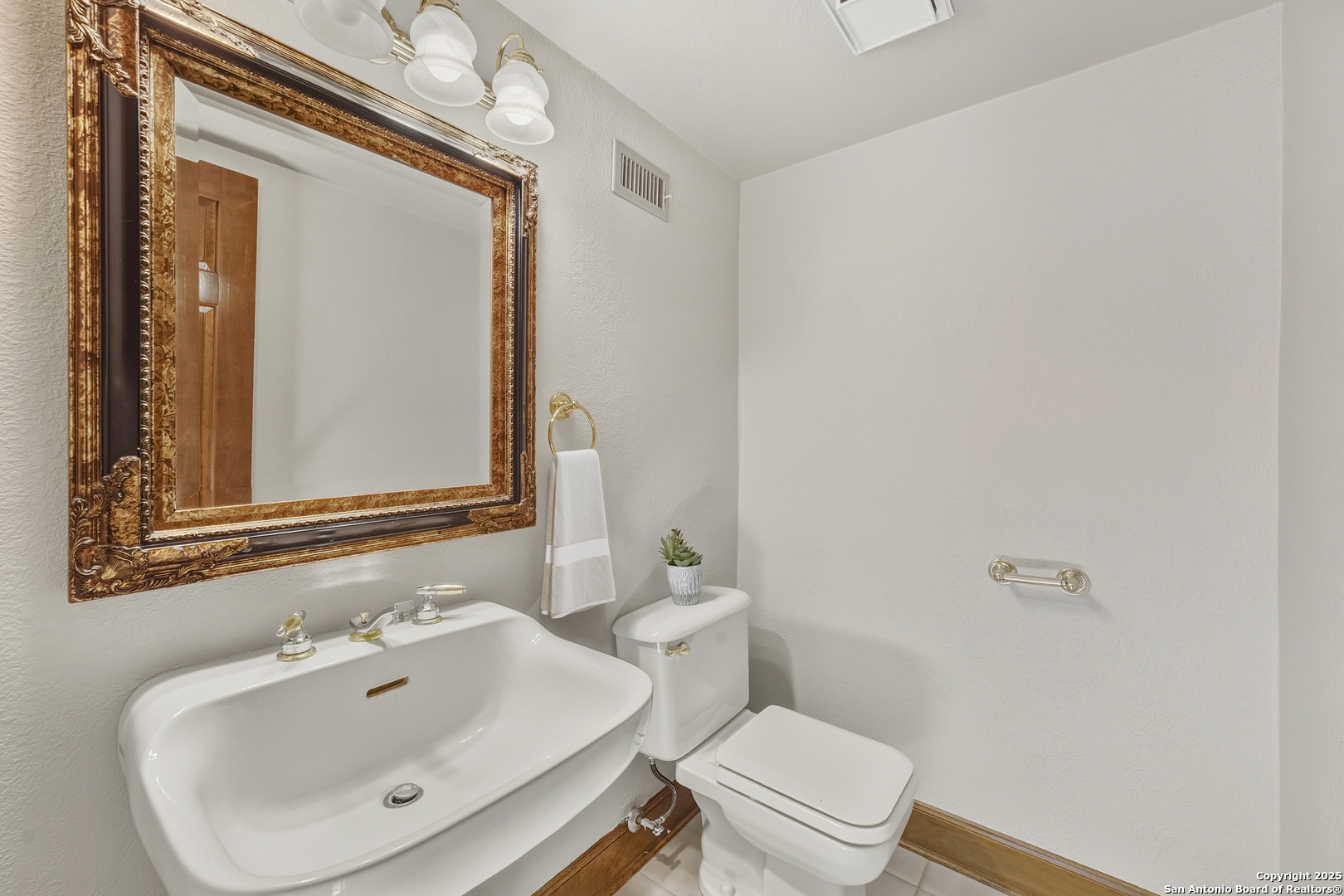 14819 Seven L Trail Helotes, TX 78023 - Photo 41 of 61 a bathroom with a sink mirror and toilet