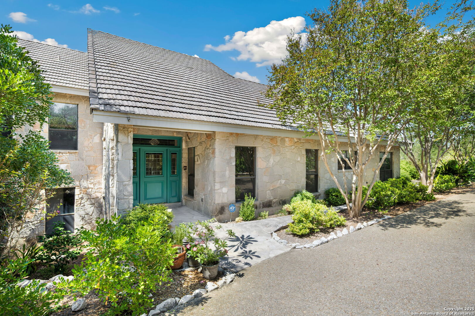 14819 Seven L Trail Helotes, TX 78023 - Photo 5 of 61 front view of a house with potted plants