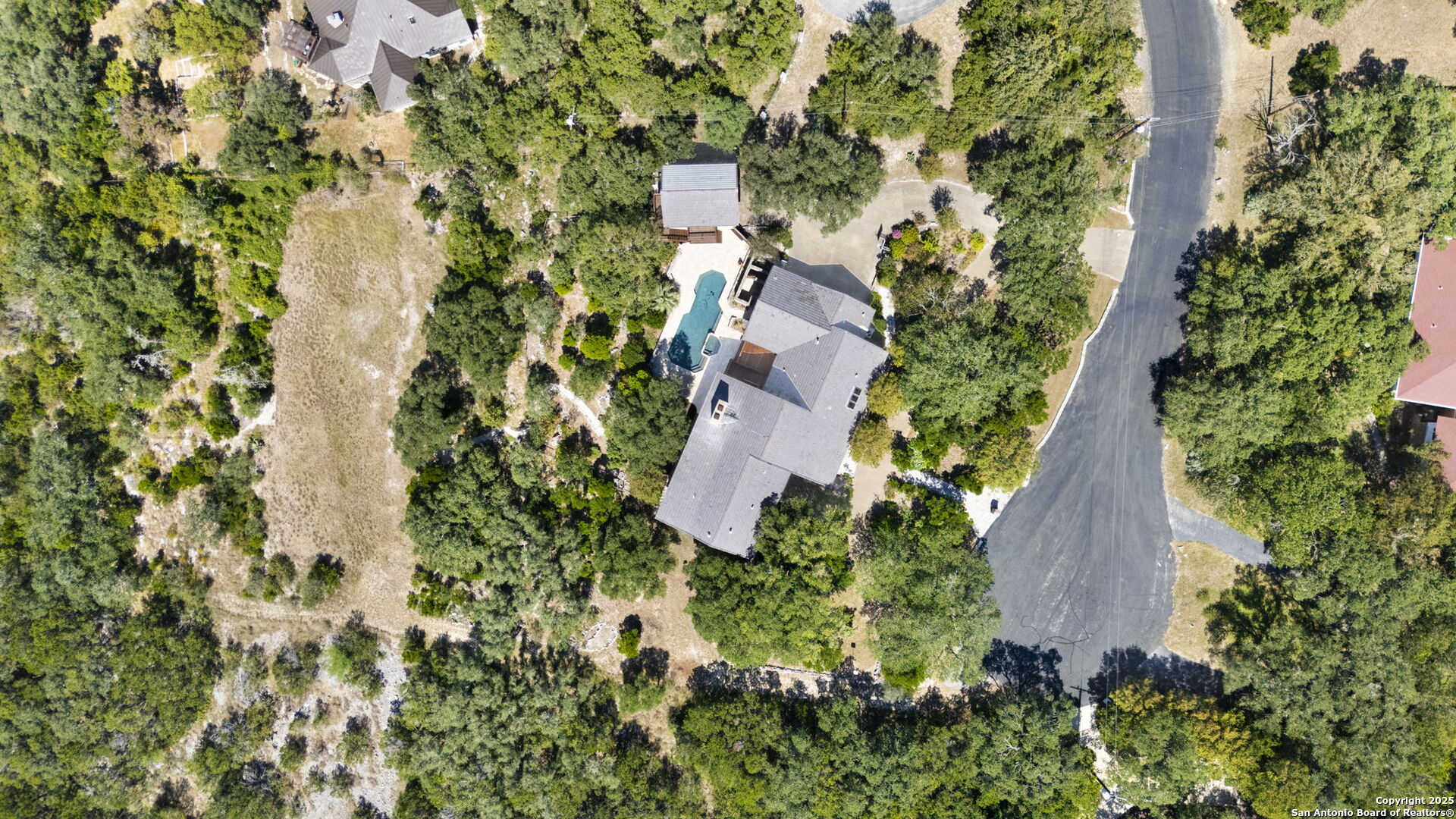 14819 Seven L Trail Helotes, TX 78023 - Photo 58 of 61 an aerial view of residential house with outdoor space and trees all around