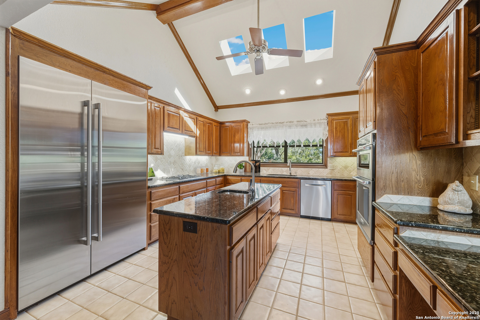 14819 Seven L Trail Helotes, TX 78023 - Photo 7 of 61 a kitchen with stainless steel appliances granite countertop a sink stove and refrigerator