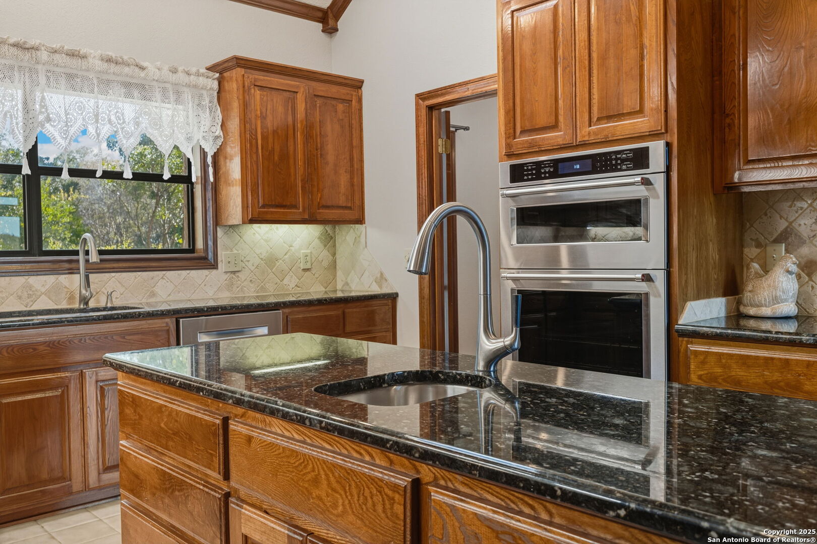 14819 Seven L Trail Helotes, TX 78023 - Photo 8 of 61 a kitchen with stainless steel appliances granite countertop a sink and cabinets