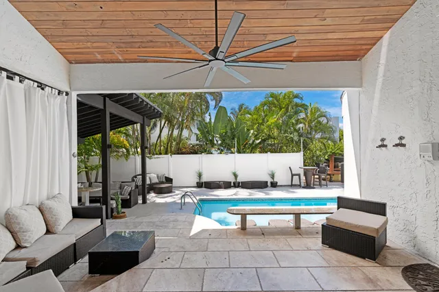 an aerial view of a house with a yard basket ball court and outdoor seating
