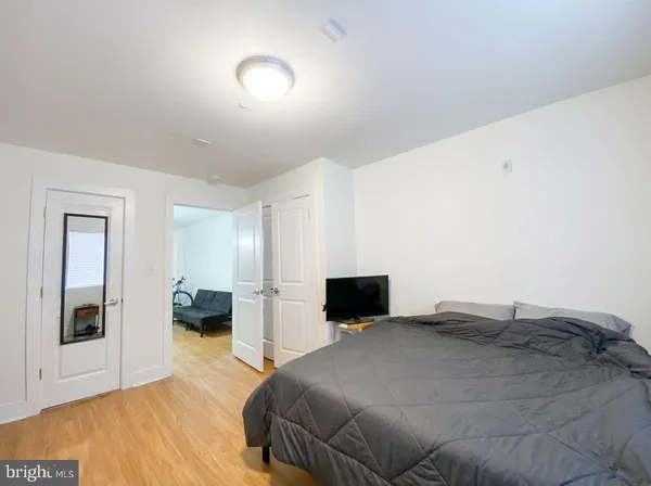 a bedroom with a bed and a view of kitchen