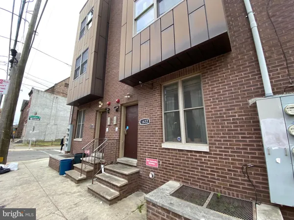 a view of a brick building with many windows