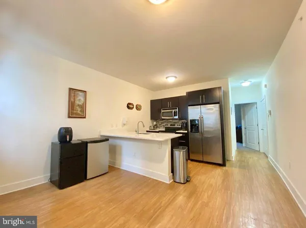 a kitchen with stainless steel appliances granite countertop a refrigerator and a sink