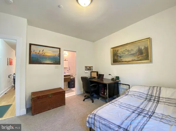a bedroom with a bed and a desk