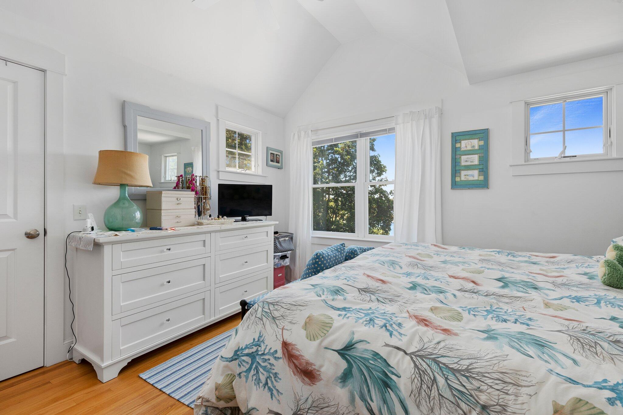 81 Mill Pond Road Chatham, MA 02633 - Photo 23 of 59 a bedroom with a large bed and a flat tv screen on dresser