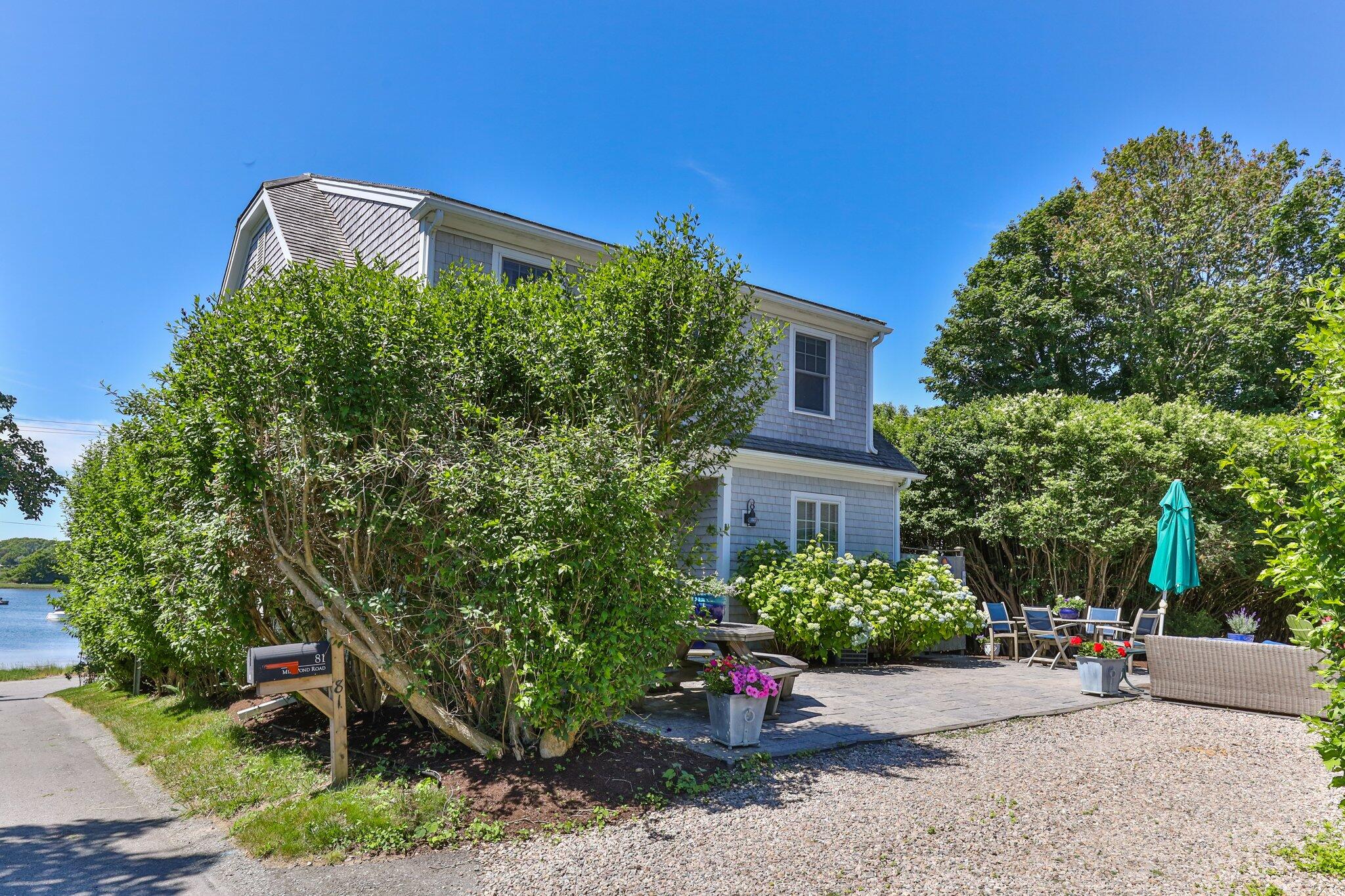 81 Mill Pond Road Chatham, MA 02633 - Photo 34 of 59 a front view of a house with a yard