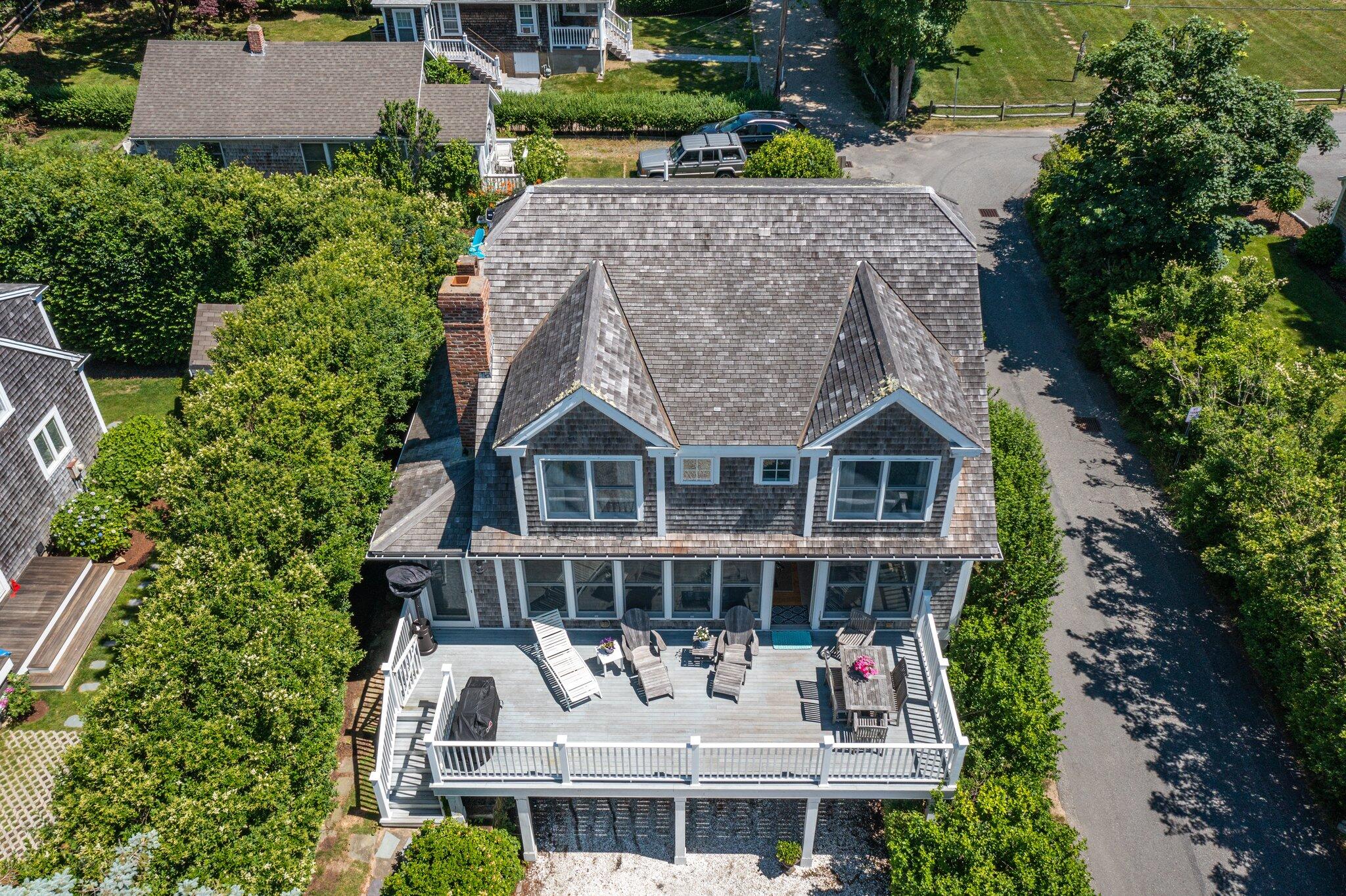 81 Mill Pond Road Chatham, MA 02633 - Photo 4 of 59 an aerial view of a house with a yard and potted plants