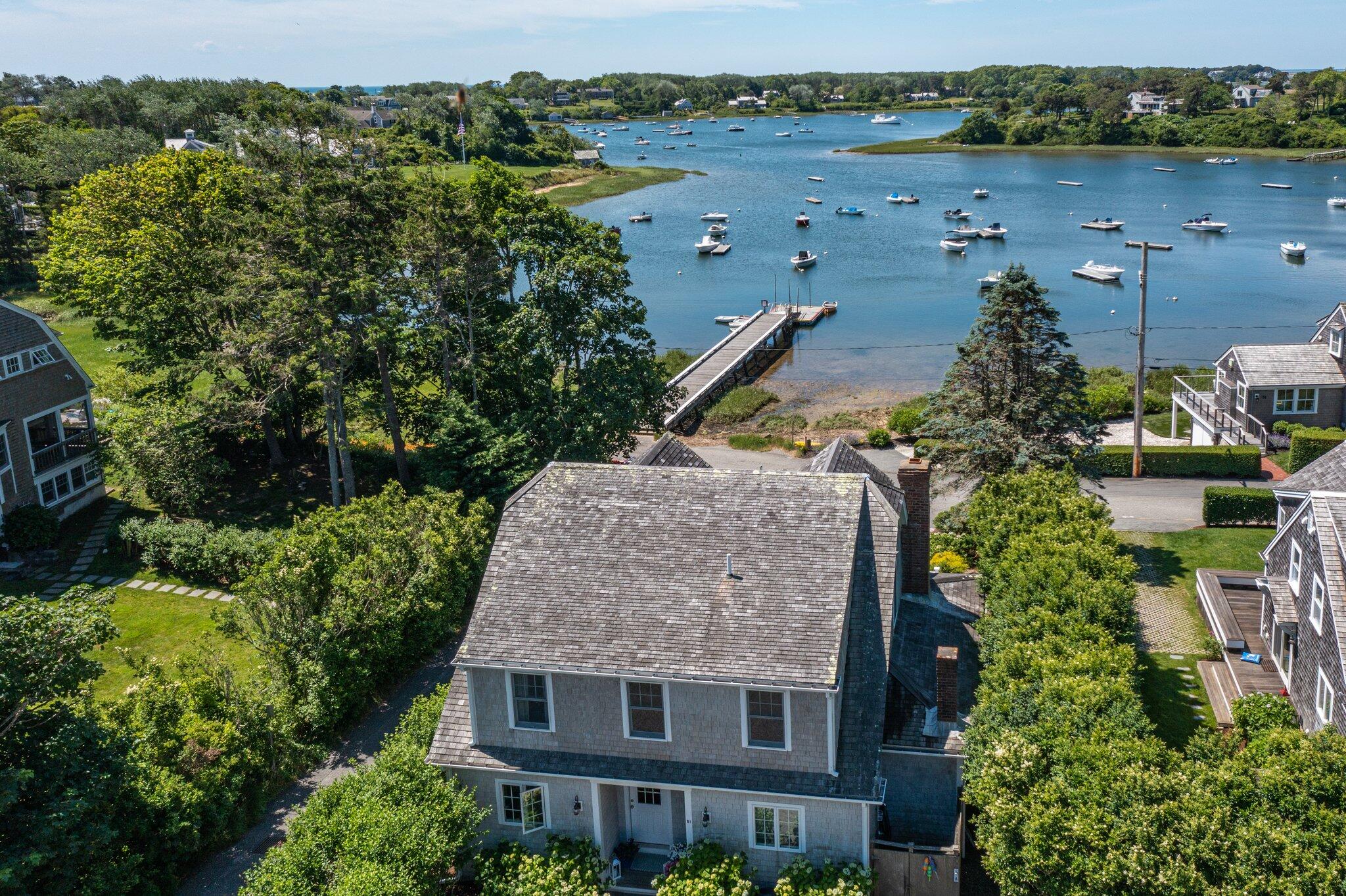 81 Mill Pond Road Chatham, MA 02633 - Photo 42 of 59 an aerial view of a house with a yard and lake view