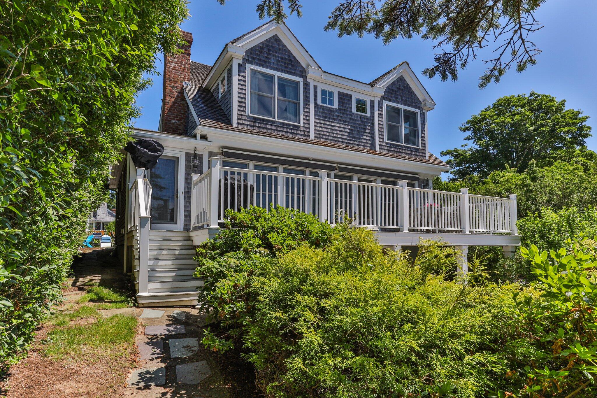 81 Mill Pond Road Chatham, MA 02633 - Photo 50 of 59 a front view of a house with garden