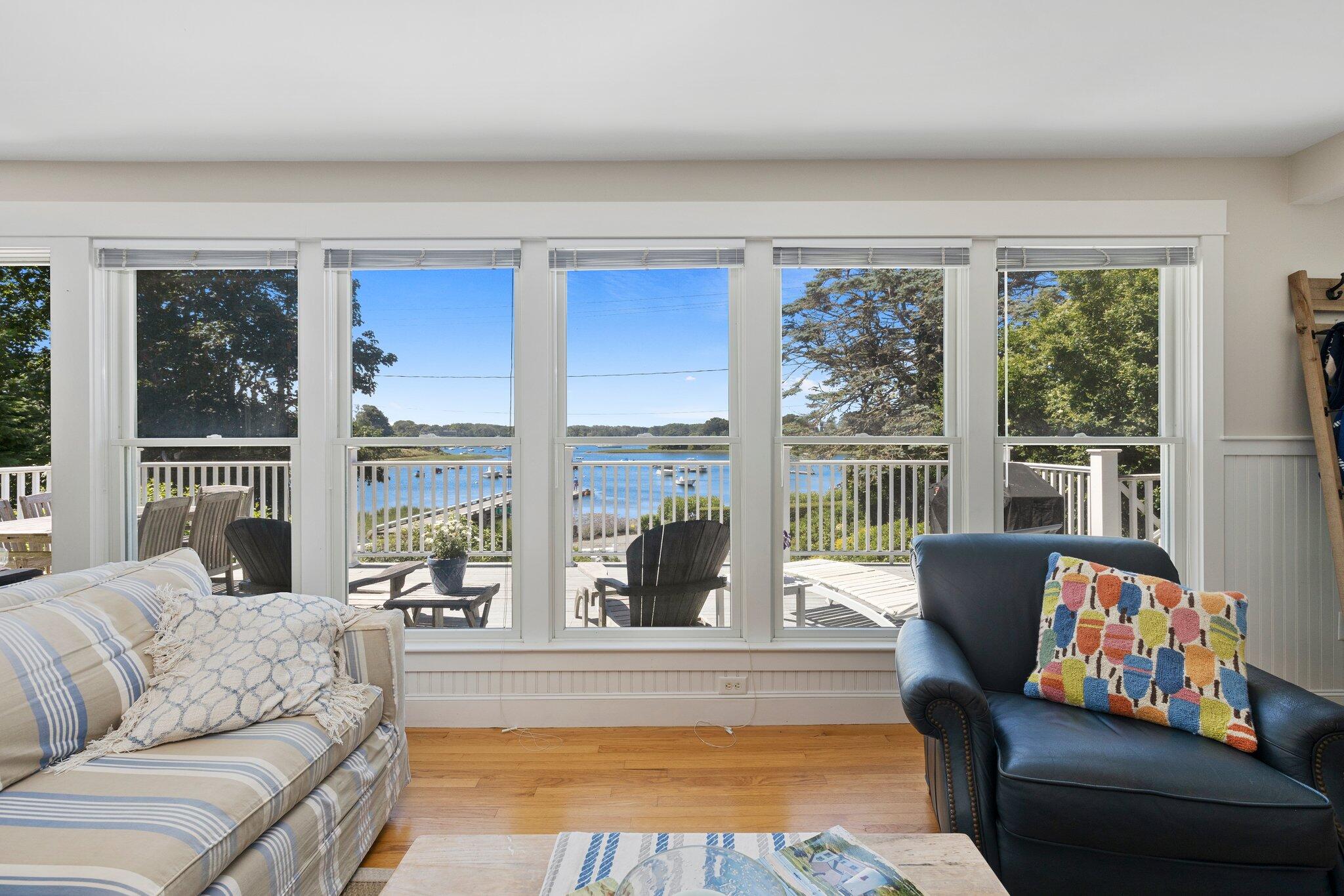 81 Mill Pond Road Chatham, MA 02633 - Photo 9 of 59 a living room with furniture and floor to ceiling windows