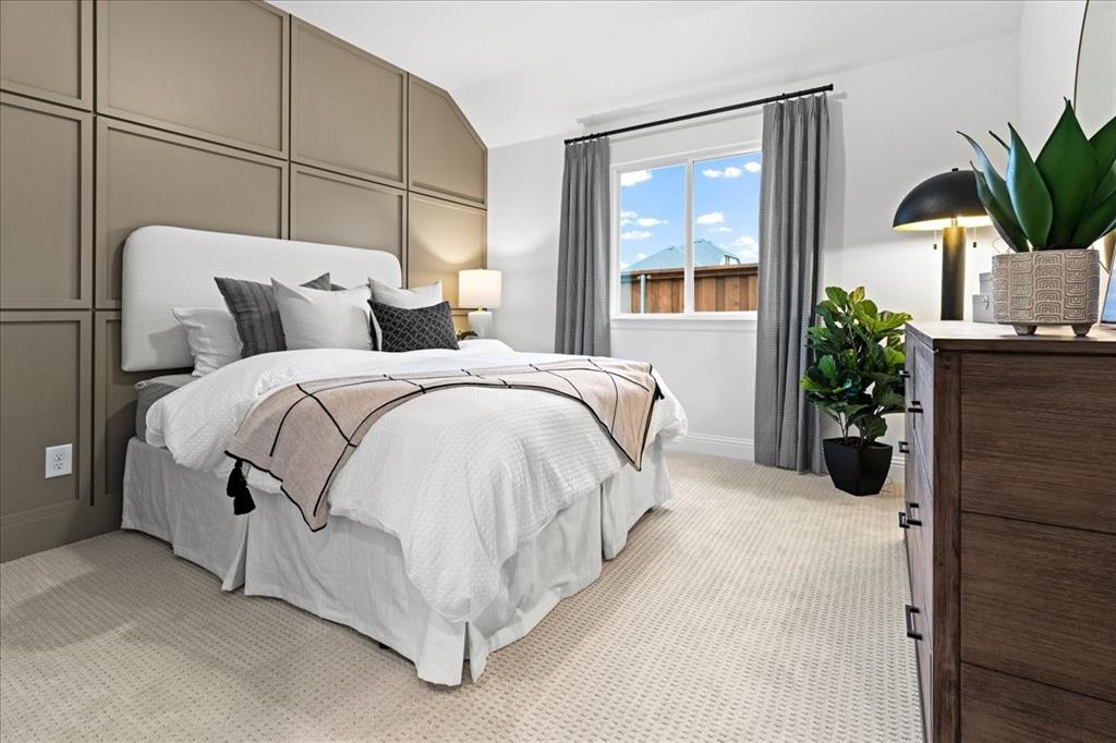 1435 Canadian Lane Van Alstyne, TX 75495 - Photo 12 of 16 a spacious bedroom with a bed a window and potted plant