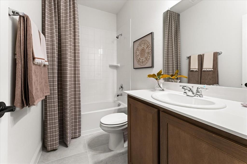 1435 Canadian Lane Van Alstyne, TX 75495 - Photo 13 of 16 a bathroom with a granite countertop toilet sink and mirror