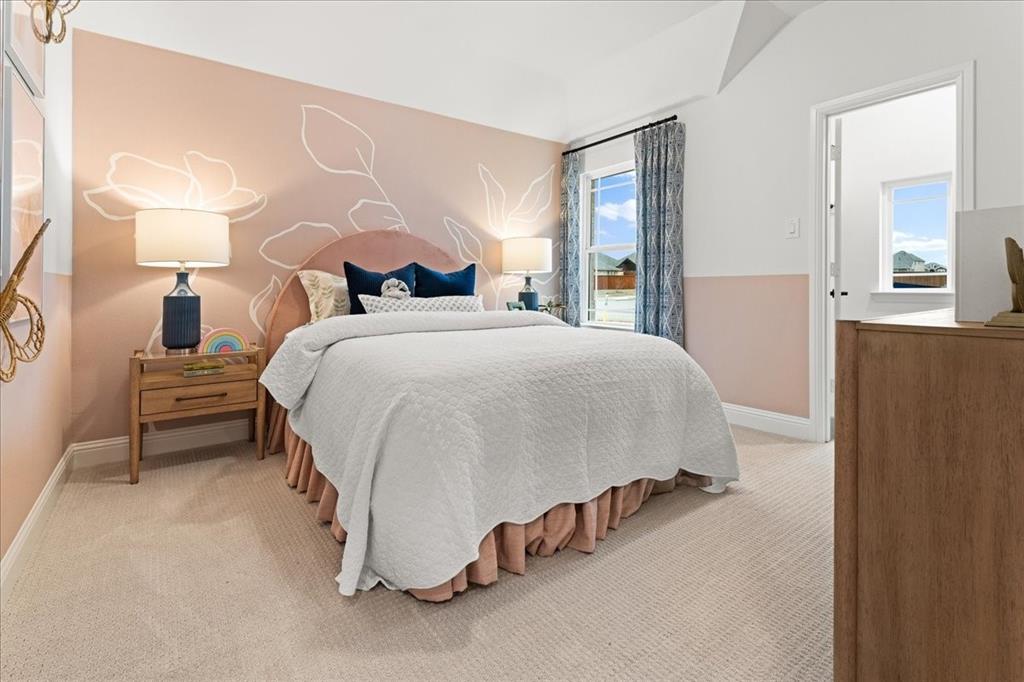 1435 Canadian Lane Van Alstyne, TX 75495 - Photo 15 of 16 a spacious bedroom with a bed and a lamp on table