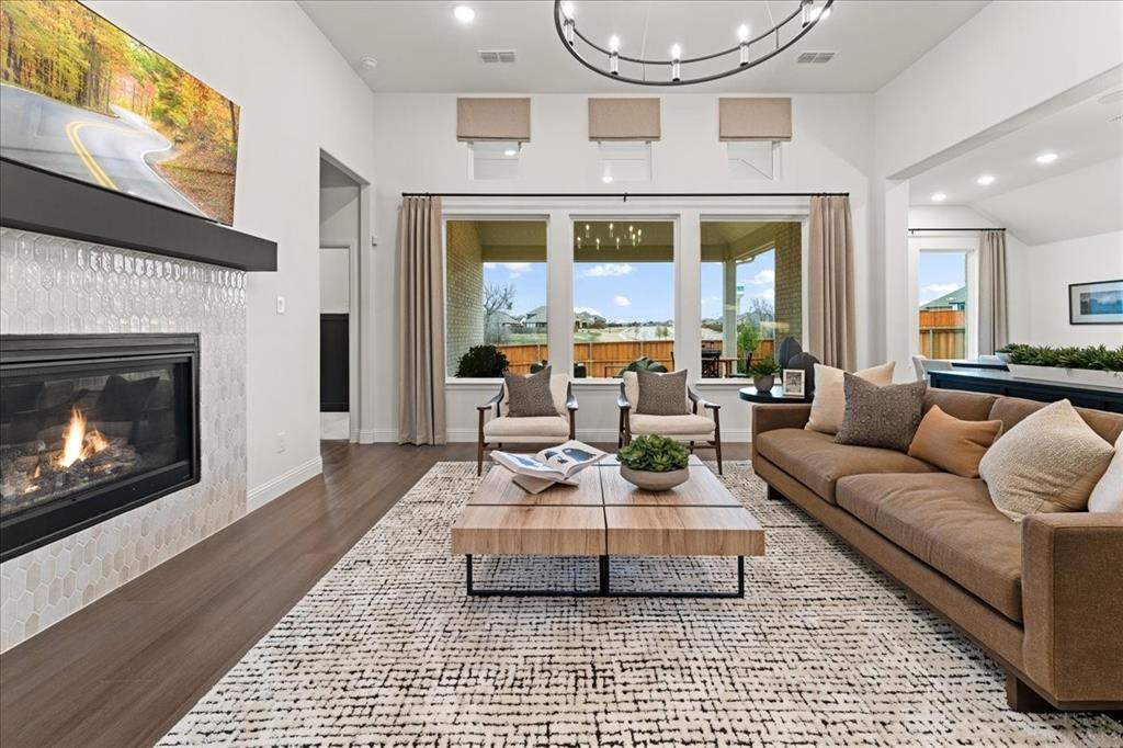 1435 Canadian Lane Van Alstyne, TX 75495 - Photo 3 of 16 a living room with furniture a fireplace and a flat screen tv