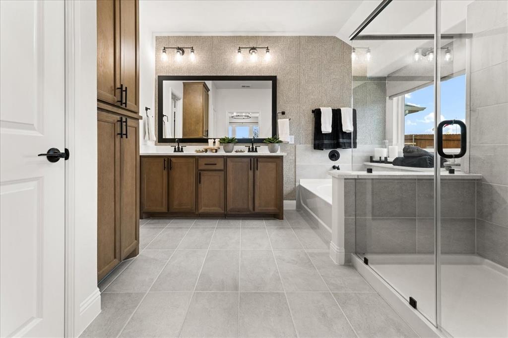 1435 Canadian Lane Van Alstyne, TX 75495 - Photo 10 of 16 a bathroom with a bathtub sink and mirror