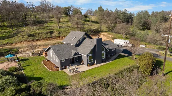 an aerial view of a house with a big yard