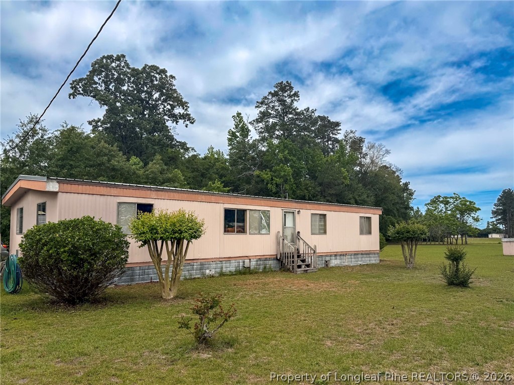 1308 Mac D Road Orrum, NC 28369 - Photo 1 of 32 a house view with a garden space