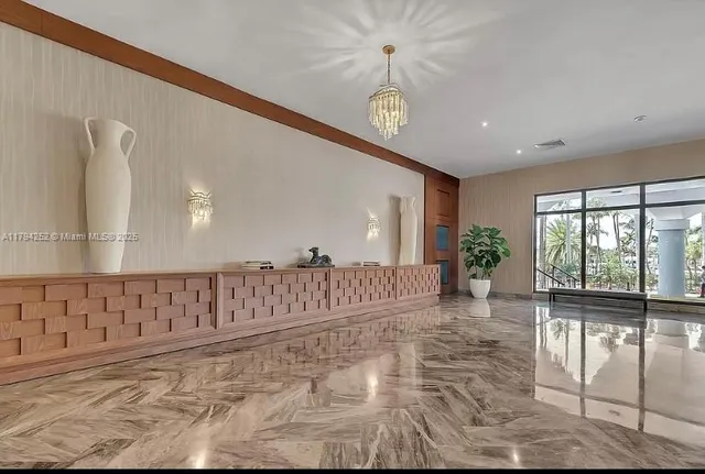 a view of entryway with a floor to ceiling window and wooden floor