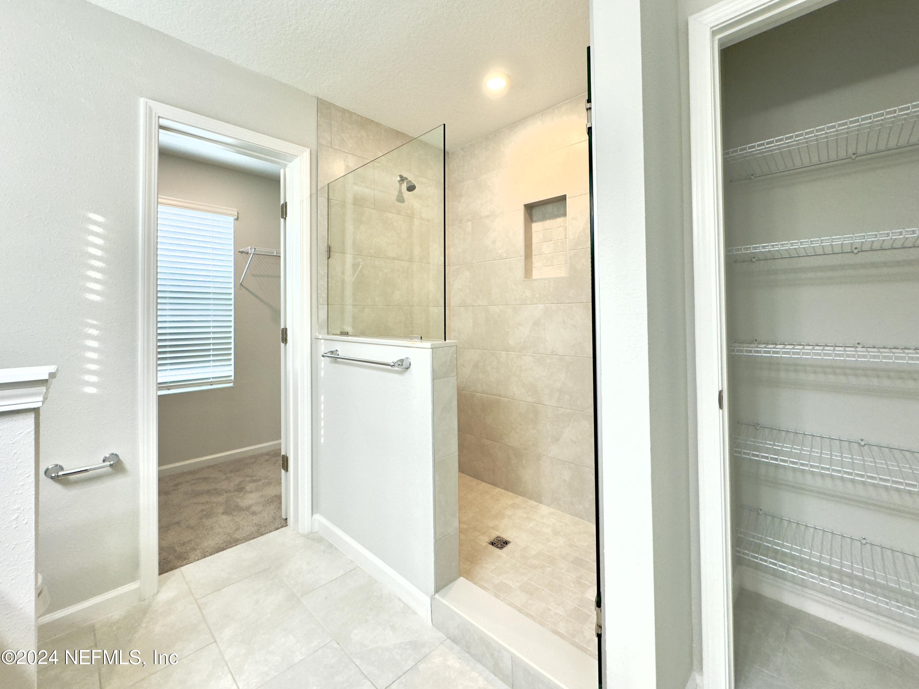 4672 Ribault Park Street Jacksonville, FL 32233 - Photo 13 of 22 a bathroom with a glass shower door and a sink