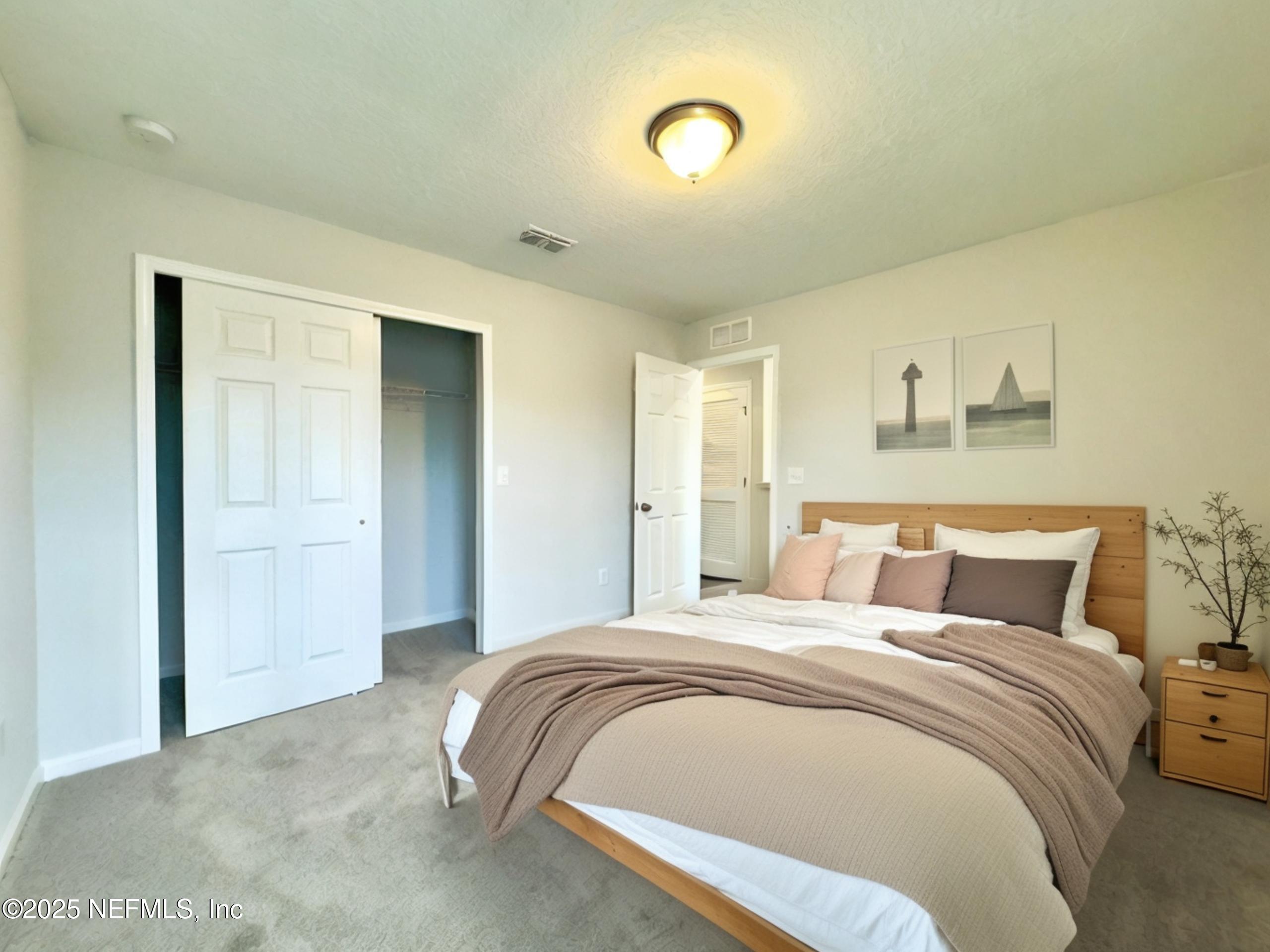 4672 Ribault Park Street Jacksonville, FL 32233 - Photo 18 of 22 a bedroom with a bed and a painting on the wall