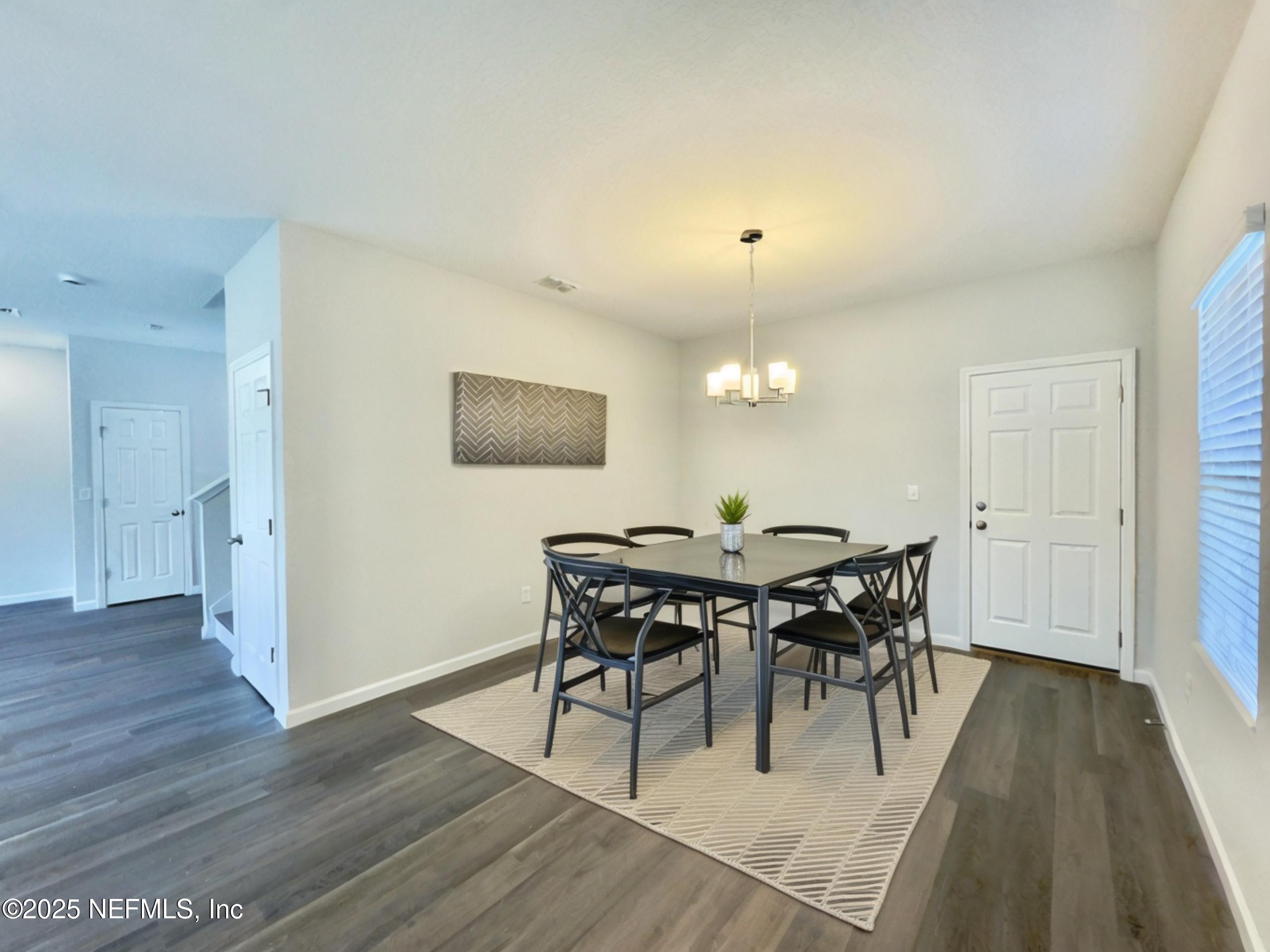 4672 Ribault Park Street Jacksonville, FL 32233 - Photo 8 of 22 a view of a dining room with furniture and wooden floor