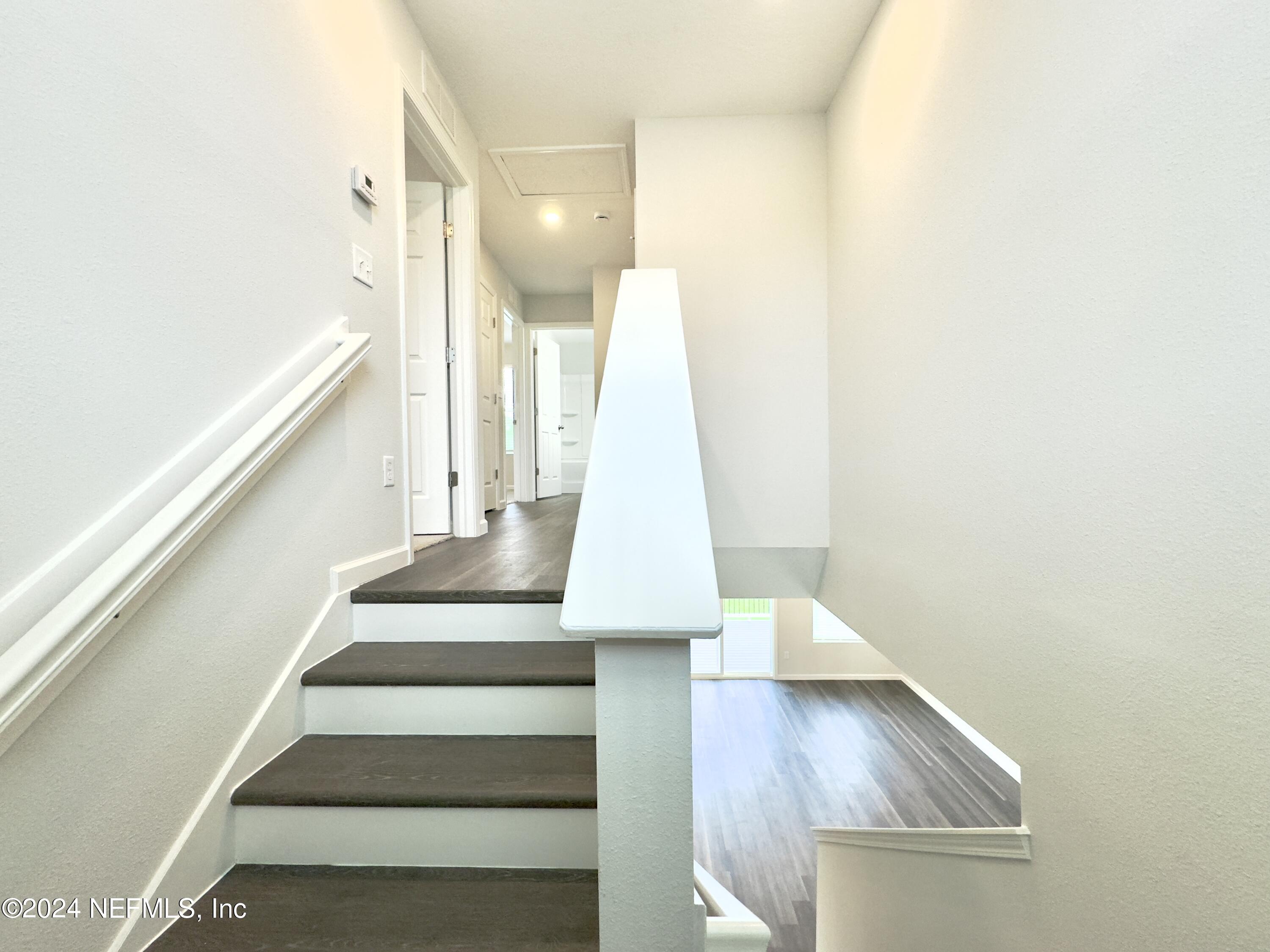 4672 Ribault Park Street Jacksonville, FL 32233 - Photo 10 of 22 a view of staircase with white walls and a window