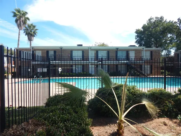 a view of a balcony with floor to ceiling window and wooden fence