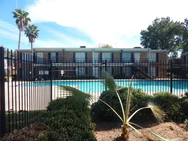a view of a balcony with floor to ceiling window and wooden fence