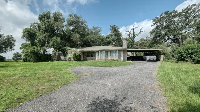 a front view of house with yard and green space