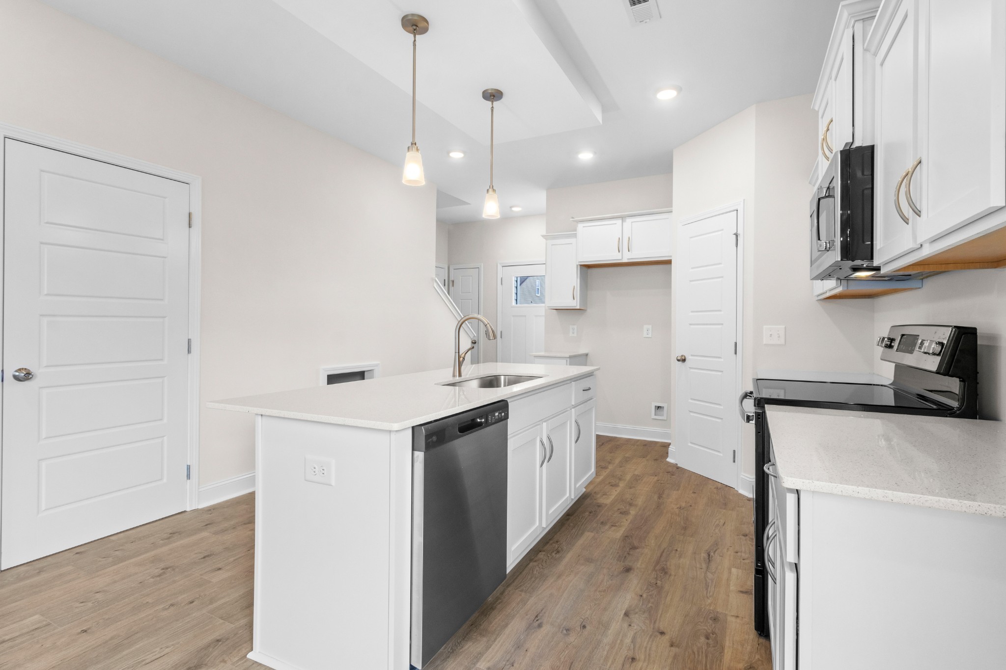 2138 Ireland Way Clarksville, TN 37042 - Photo 12 of 37 a kitchen with a sink a stove and a refrigerator