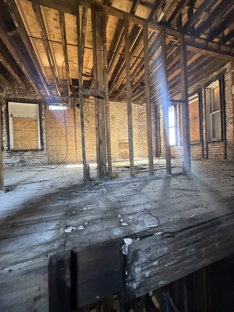 3600 West 16th Street Chicago, IL 60623 - Photo 21 of 21 a view of an empty room with wooden floor and a window