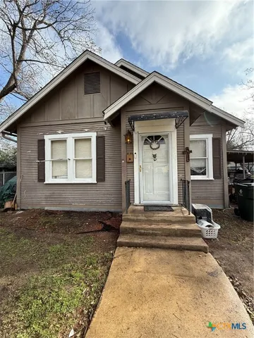 a house with trees in the background