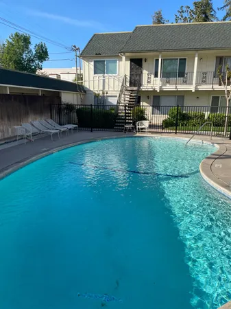 an outdoor view of house with swimming pool and outdoor seating