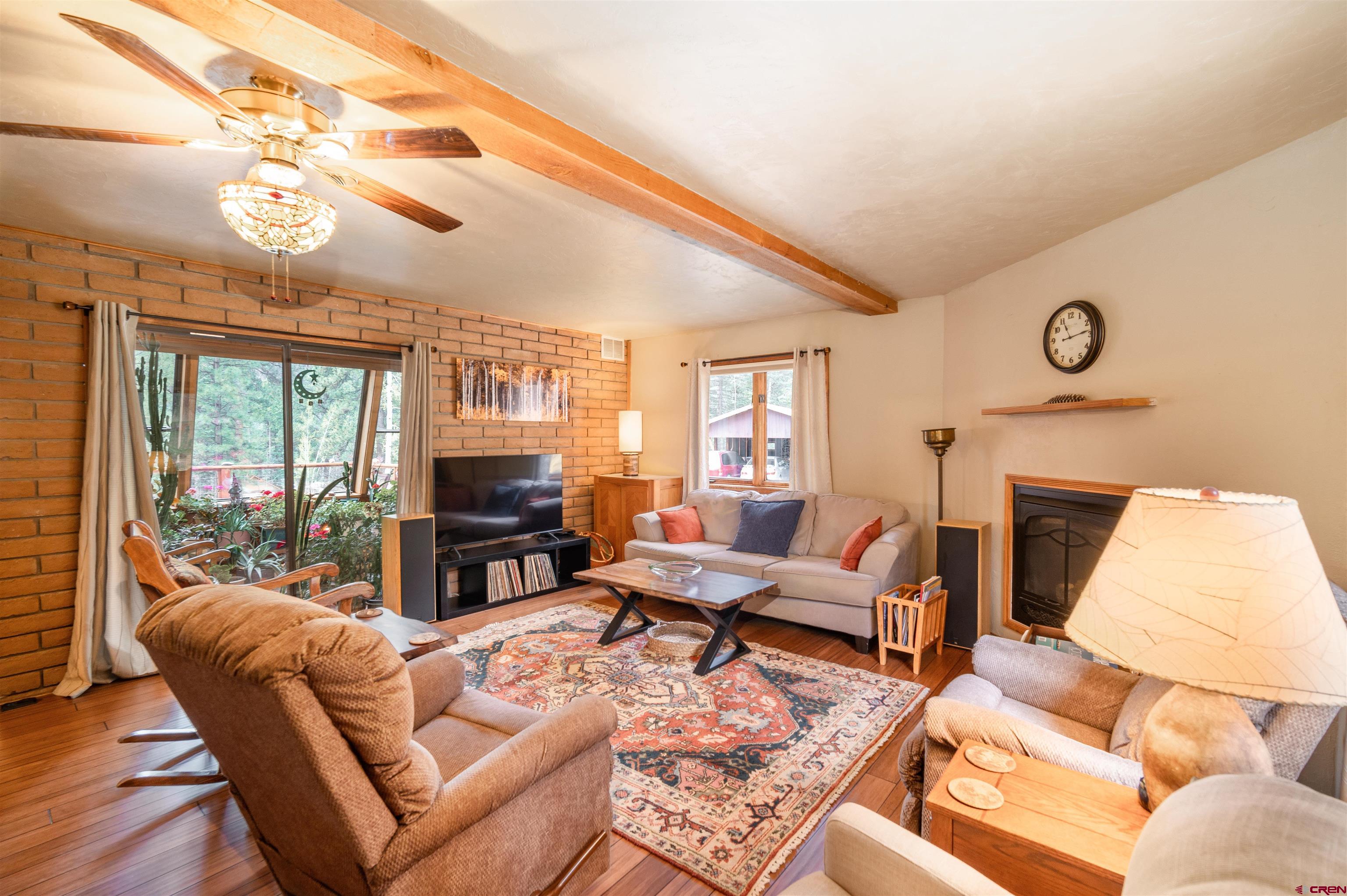 520 Los Ranchitos Drive Durango, CO 81301 - Photo 11 of 36 a living room with furniture a fireplace and a large window