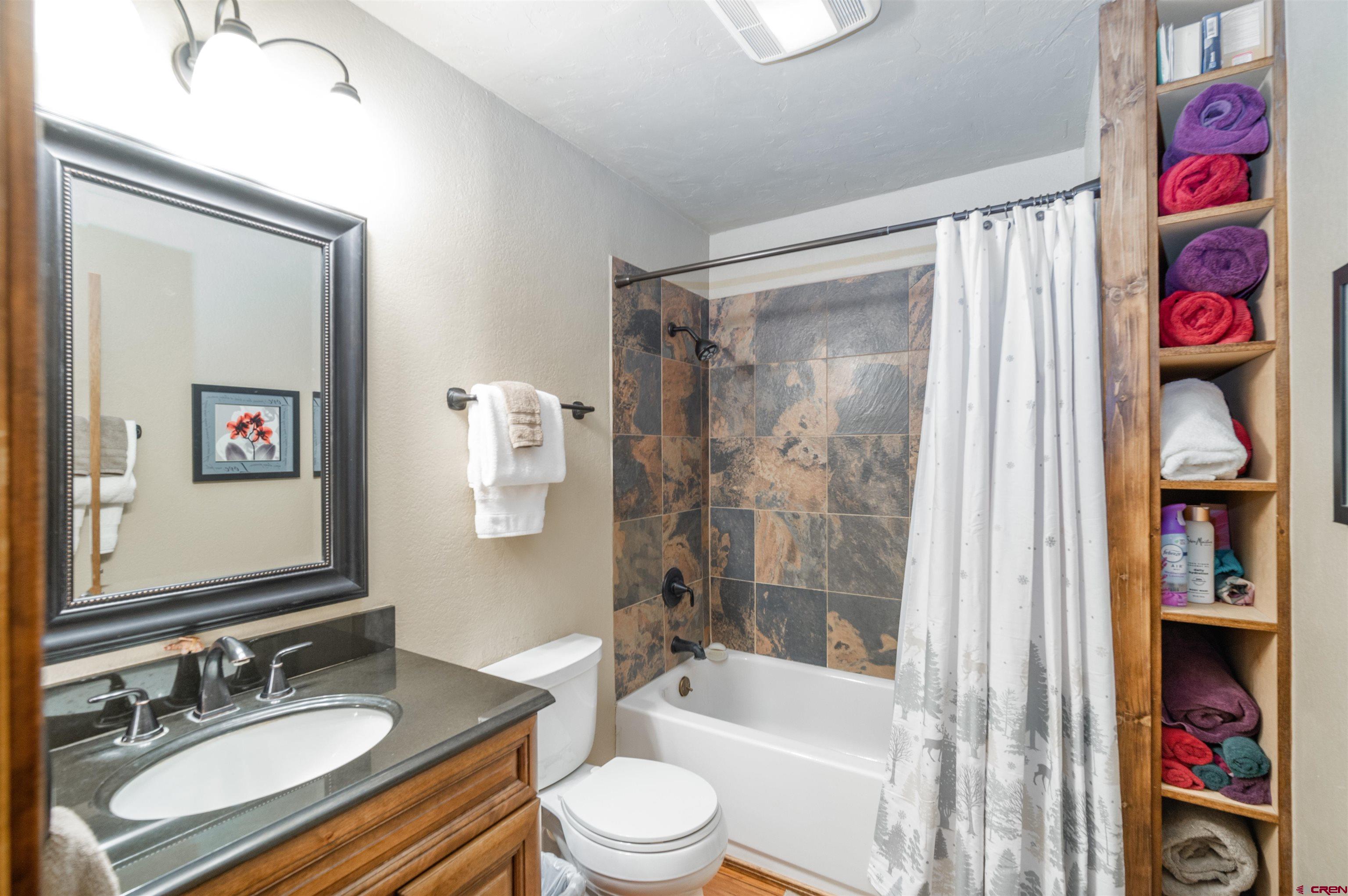 520 Los Ranchitos Drive Durango, CO 81301 - Photo 13 of 36 a bathroom with a granite countertop sink toilet and shower