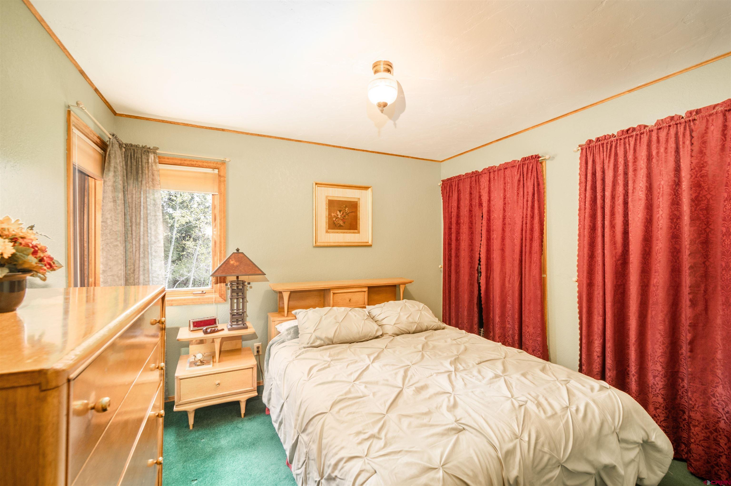 520 Los Ranchitos Drive Durango, CO 81301 - Photo 14 of 36 a bedroom with a bed and wooden floor