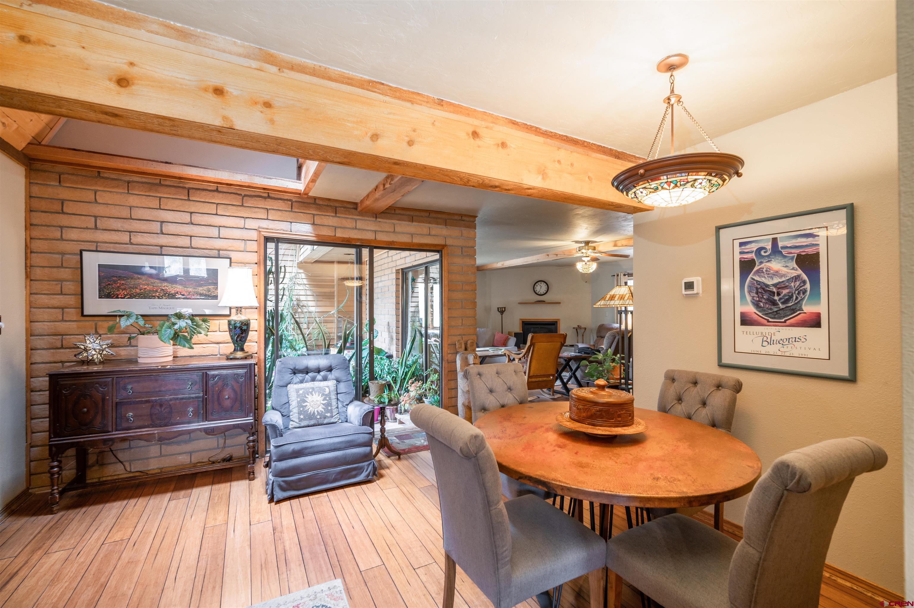 520 Los Ranchitos Drive Durango, CO 81301 - Photo 17 of 36 a dining room with furniture a chandelier and wooden floor